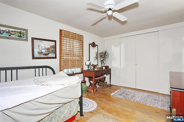 bedroom with a closet, a ceiling fan, and wood finished floors