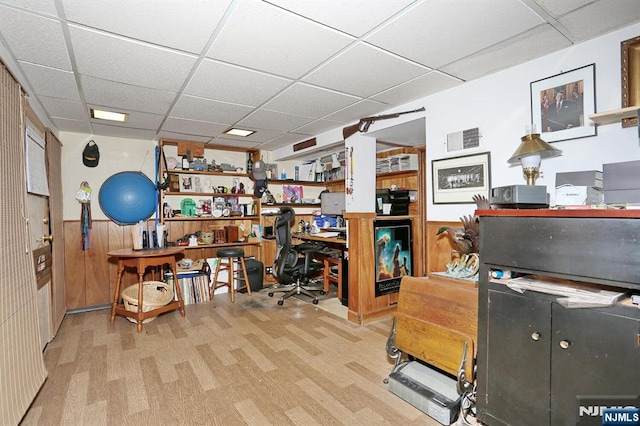 home office with visible vents, a drop ceiling, and wood finished floors