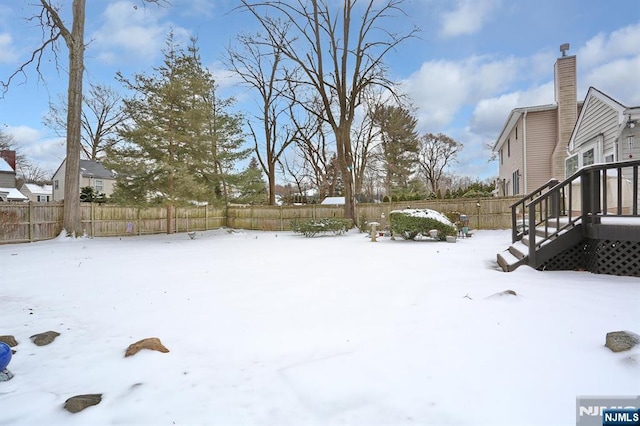 yard covered in snow featuring a fenced backyard