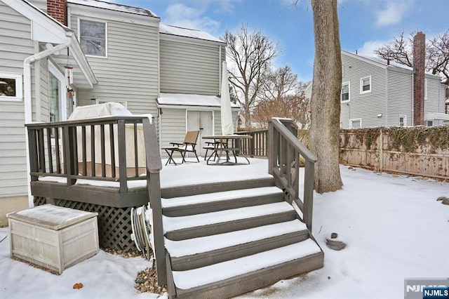 snow covered deck with fence