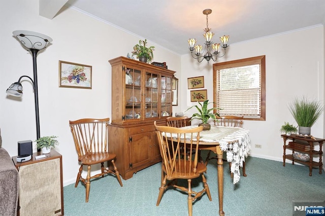 dining area featuring crown molding, carpet floors, baseboards, and a notable chandelier