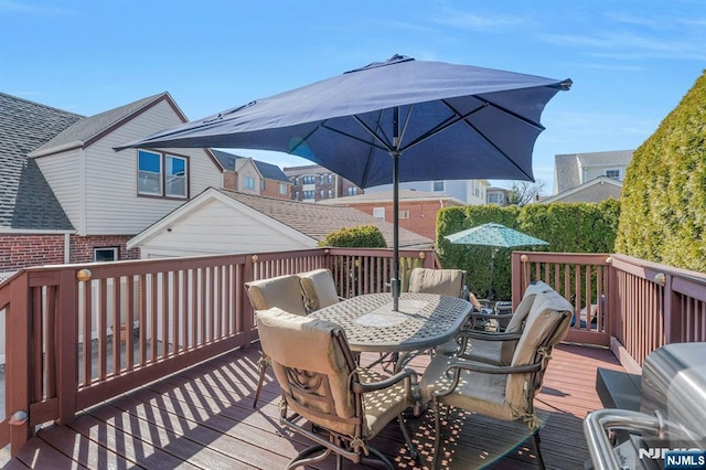 wooden terrace featuring outdoor dining area