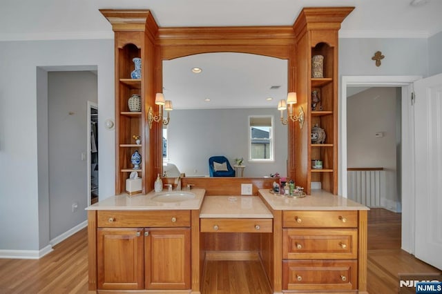 kitchen featuring open shelves, light wood finished floors, and a sink