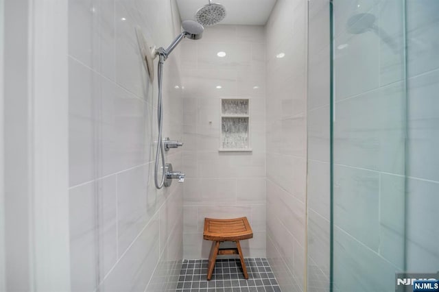 full bath with a tile shower