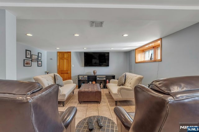 living room featuring light tile patterned flooring, recessed lighting, and visible vents