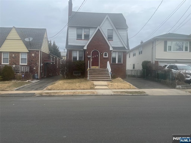 view of front of property featuring brick siding and fence