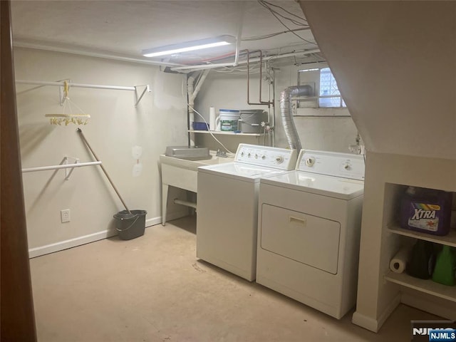 clothes washing area featuring laundry area, independent washer and dryer, and baseboards