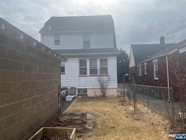 rear view of property with fence