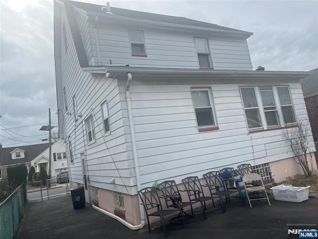 back of house with fence