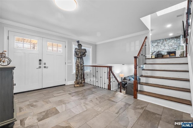 foyer with visible vents, ornamental molding, stairway, and a wealth of natural light