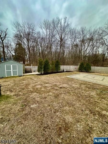 view of yard featuring an outdoor structure and fence