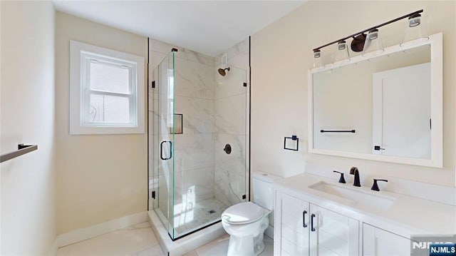 full bathroom with baseboards, a shower stall, toilet, and vanity