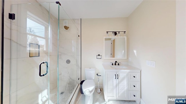 bathroom featuring vanity, a shower stall, and toilet