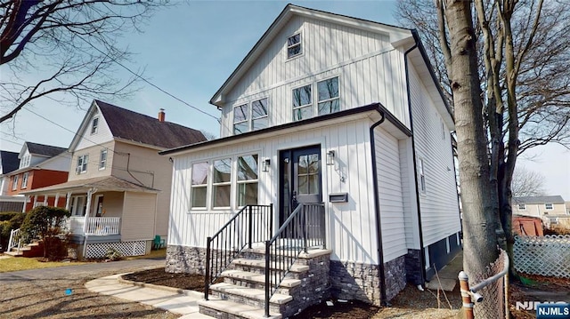 view of front facade with covered porch and board and batten siding