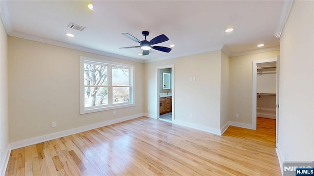 unfurnished bedroom with baseboards, crown molding, visible vents, and light wood-style floors