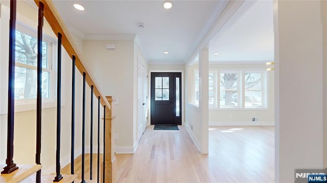 entrance foyer featuring ornamental molding, recessed lighting, light wood finished floors, and stairs