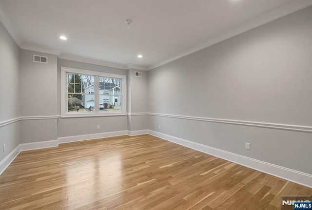 unfurnished room with light wood-style floors, baseboards, and visible vents