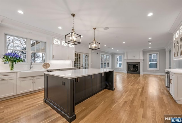 kitchen featuring light countertops, white cabinetry, and a sink