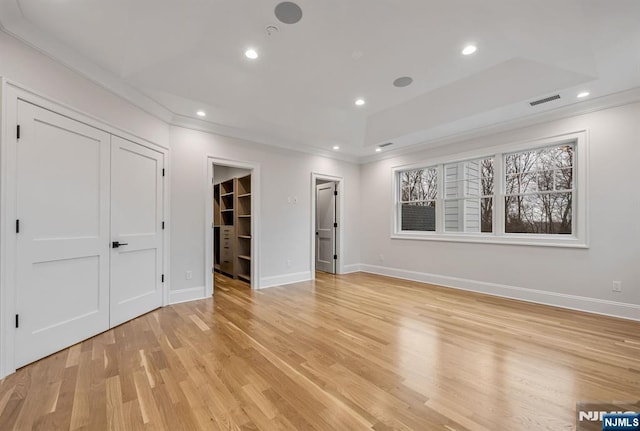 unfurnished room with recessed lighting, light wood-type flooring, visible vents, and crown molding