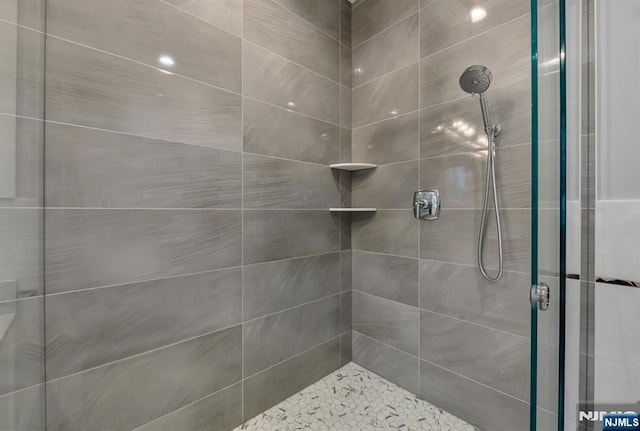 full bath featuring a tile shower