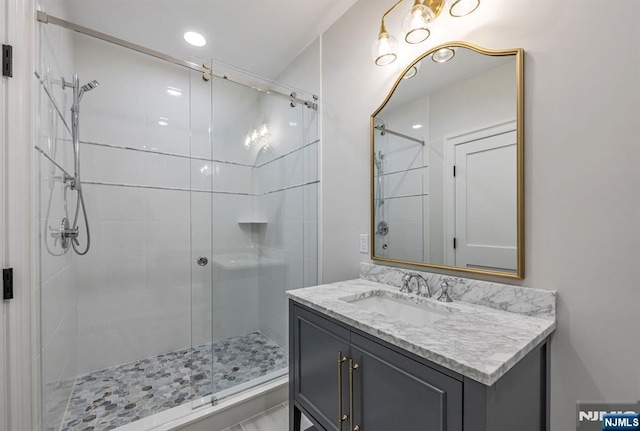 bathroom featuring a stall shower and vanity