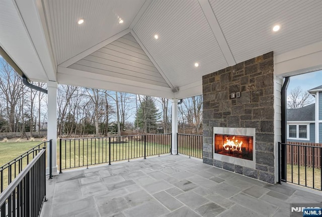 view of patio / terrace featuring an outdoor stone fireplace