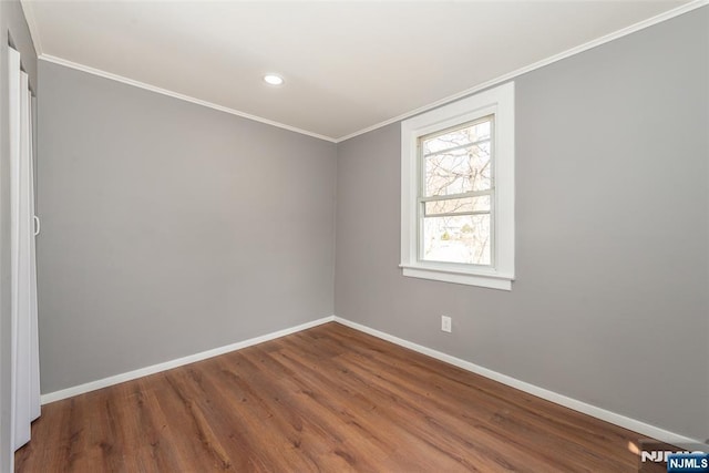 empty room featuring recessed lighting, baseboards, wood finished floors, and ornamental molding