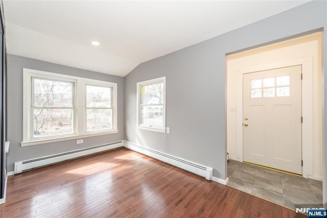 entryway with lofted ceiling, a baseboard radiator, baseboards, and hardwood / wood-style floors