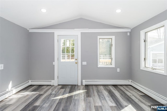 foyer entrance featuring lofted ceiling, baseboard heating, wood finished floors, and recessed lighting