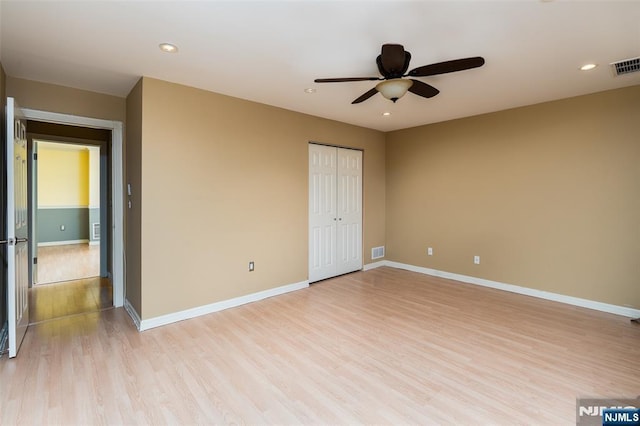 unfurnished bedroom featuring light wood-type flooring, visible vents, and baseboards