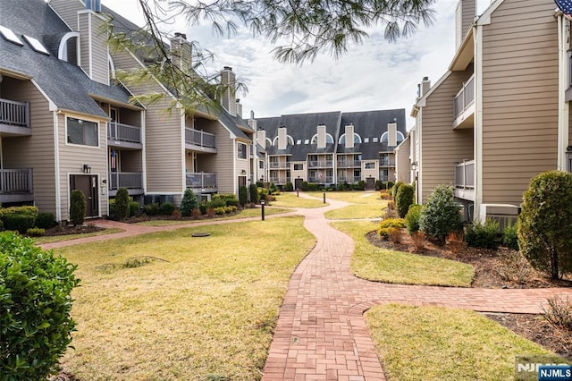 view of home's community with a yard