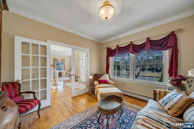 sitting room with ornamental molding, french doors, a baseboard heating unit, and wood finished floors