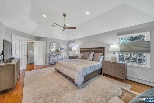 bedroom with wood finished floors, visible vents, a baseboard radiator, lofted ceiling, and recessed lighting