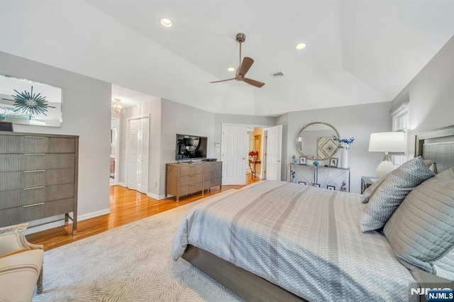 bedroom with vaulted ceiling, recessed lighting, wood finished floors, and visible vents