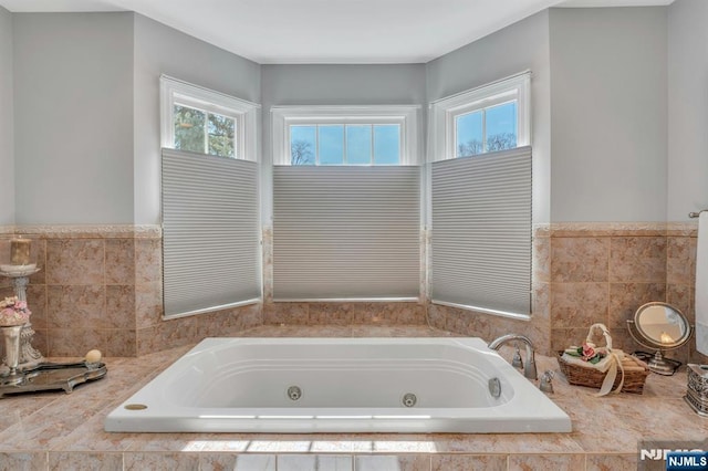 bathroom featuring a tub with jets