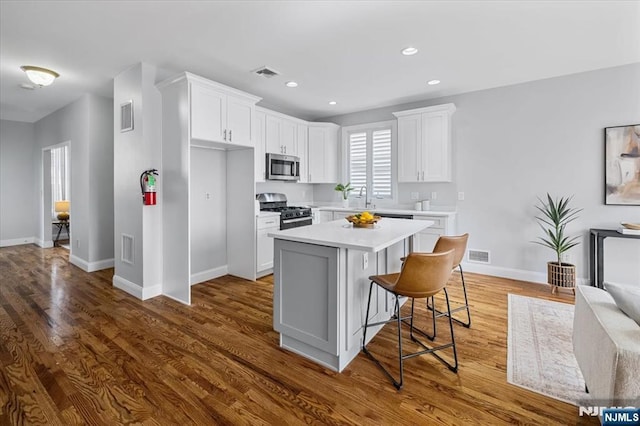 kitchen with stainless steel appliances, light countertops, and visible vents