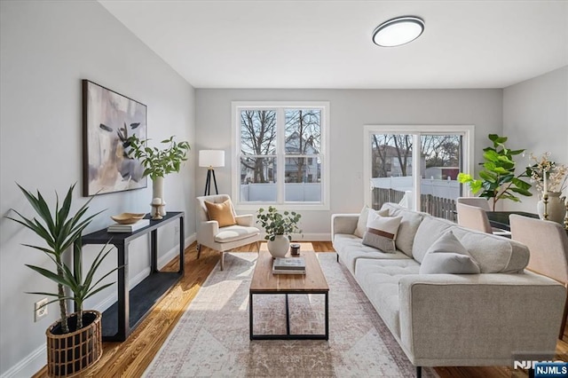 living area with wood finished floors and baseboards