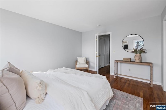 bedroom featuring wood finished floors and baseboards