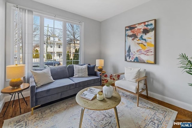 sitting room with wood finished floors and baseboards