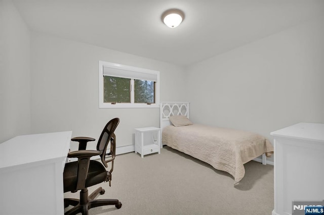 bedroom with baseboards and light colored carpet