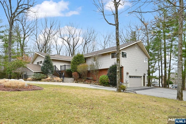 view of front of home with a garage, stairway, aphalt driveway, a front yard, and brick siding