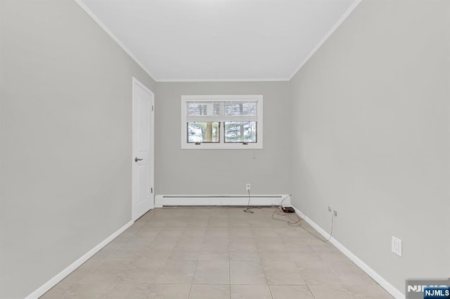 spare room with a baseboard heating unit, ornamental molding, and baseboards