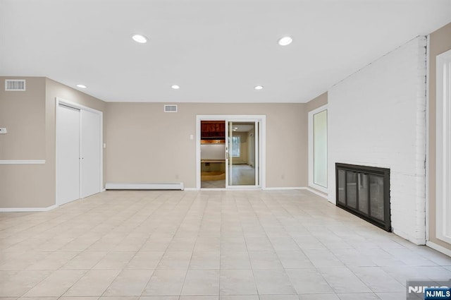 unfurnished living room featuring a brick fireplace, visible vents, baseboard heating, and recessed lighting