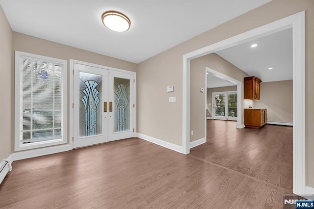 entryway featuring baseboards, dark wood-type flooring, baseboard heating, french doors, and a baseboard heating unit