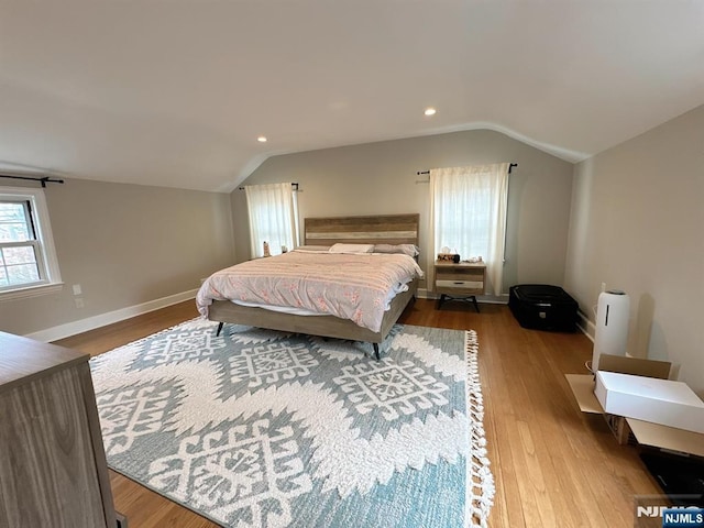 bedroom with baseboards, vaulted ceiling, wood finished floors, and recessed lighting