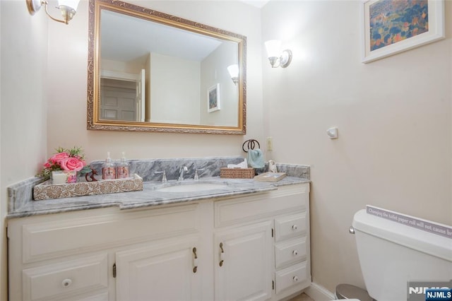 bathroom featuring toilet and vanity