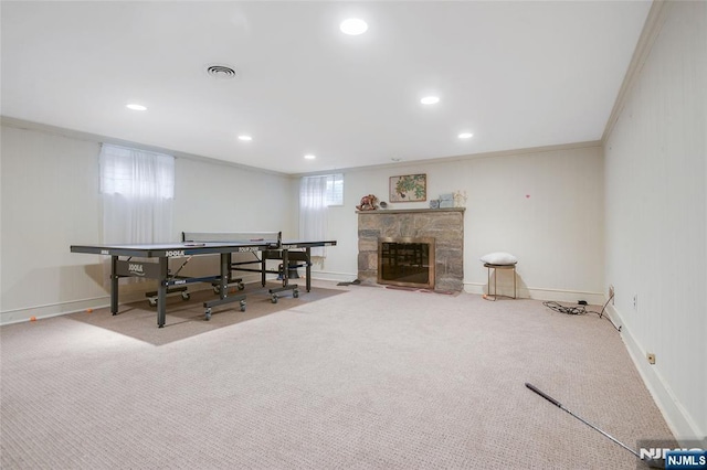 interior space with carpet, visible vents, crown molding, and a fireplace