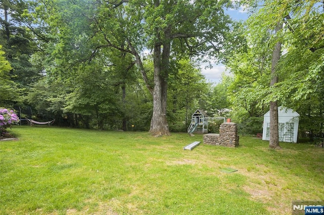 view of yard with an outbuilding and a shed