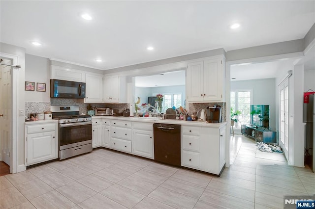 kitchen with tasteful backsplash, recessed lighting, light countertops, white cabinetry, and black appliances