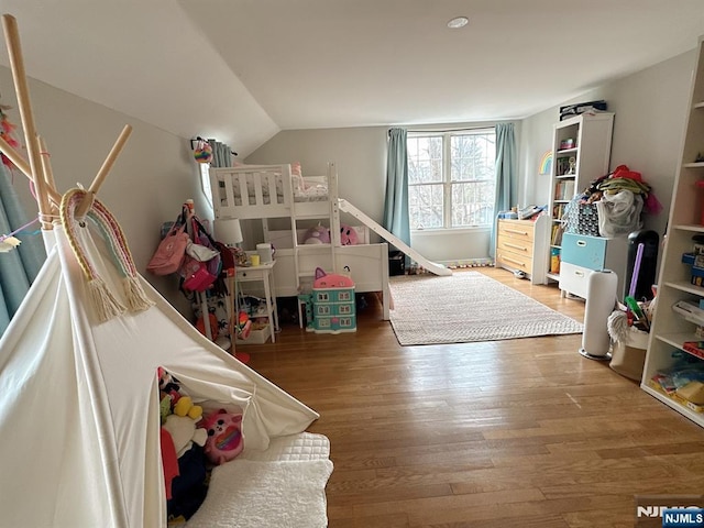 bedroom featuring lofted ceiling and wood finished floors